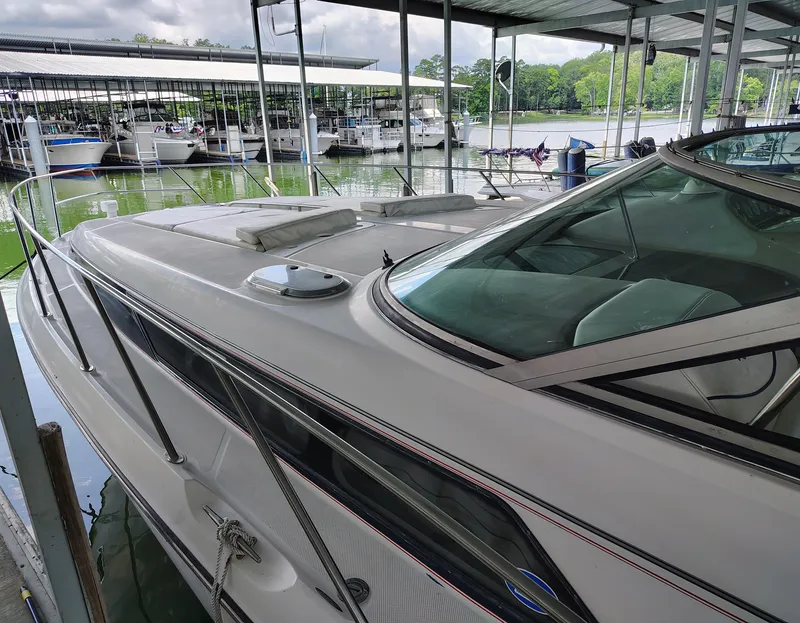 Slide: The Image of 1997 Bayliner 4085 Avanti docked in a marina, featuring sleek design and spacious deck. - 9