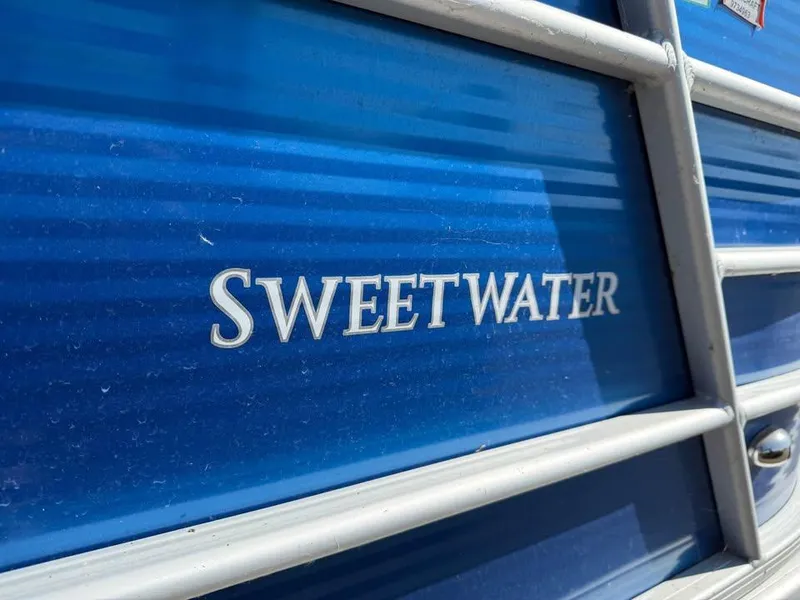 Slide: The Image of Close-up of 2020 Godfrey Sweetwater 2086 CX boat with blue exterior. - 12