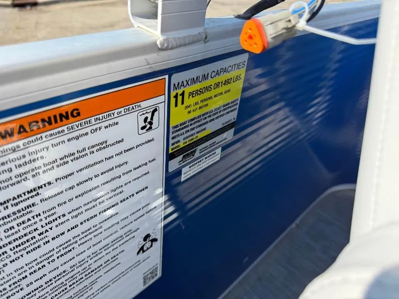 Slide: The Image of Warning and capacity labels on a 2020 Godfrey Sweetwater 2086 CX boat. - 13