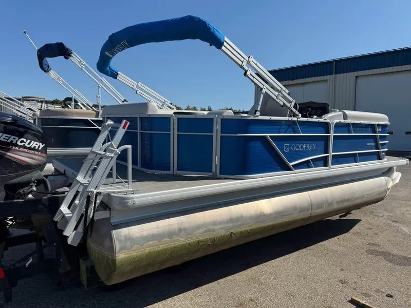 Slide: The Image of 2020 Godfrey Sweetwater 2086 CX pontoon boat with blue exterior and Mercury outboard motor. - 3