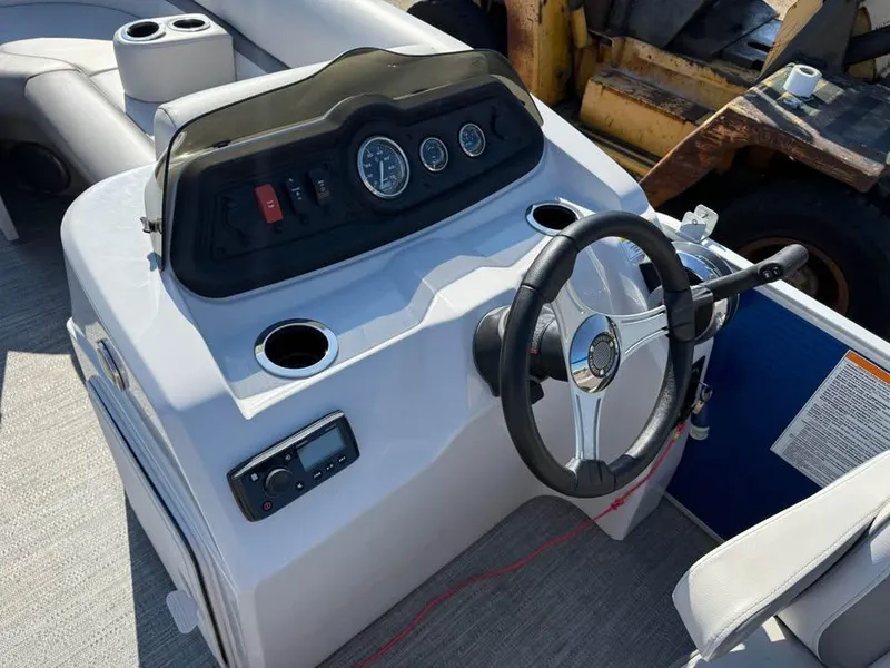 Slide: The Image of Control console of a 2020 Godfrey Sweetwater 2086 CX pontoon boat with steering wheel and gauges. - 8