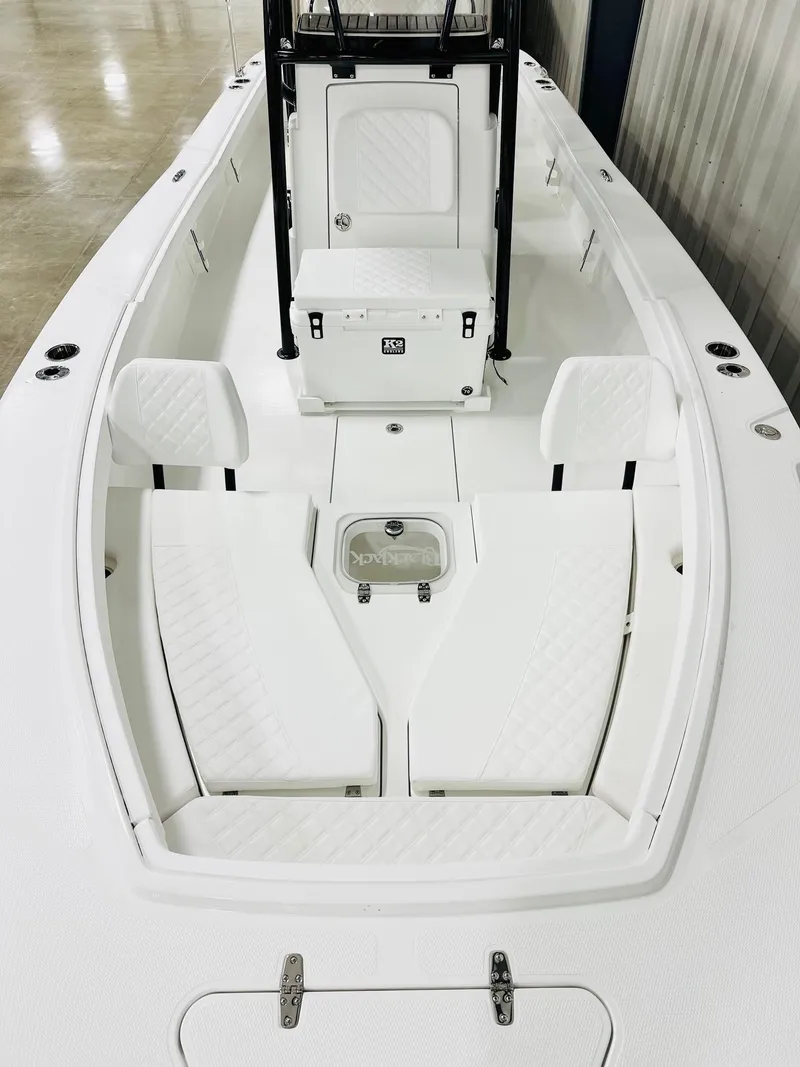Slide: The Image of 2026 BlackJack Blackjack 256 Coastal boat interior with white seating and storage compartments. - 12