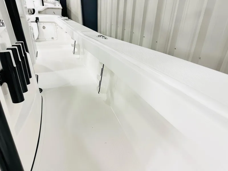 Slide: The Image of 2026 BlackJack Blackjack 256 Coastal boat interior, featuring sleek white design and rod holders. - 14