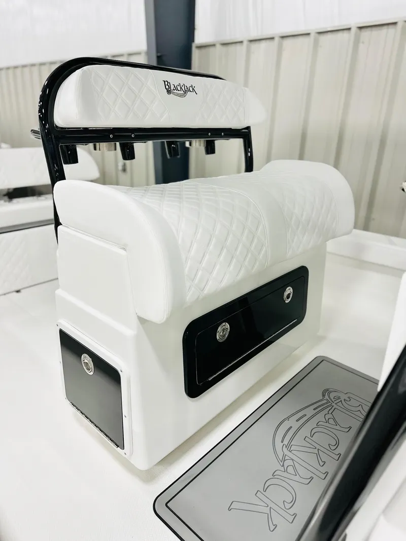 Slide: The Image of 2026 BlackJack Blackjack 256 Coastal boat seat with white quilted upholstery and storage compartments. - 4