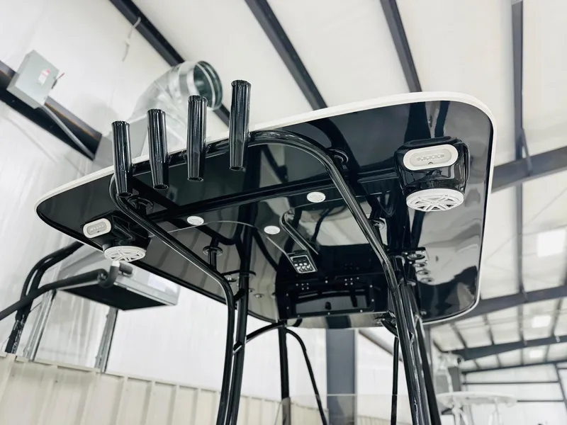 Slide: The Image of 2026 BlackJack Blackjack 256 Coastal boat interior with speakers and rod holders. - 7