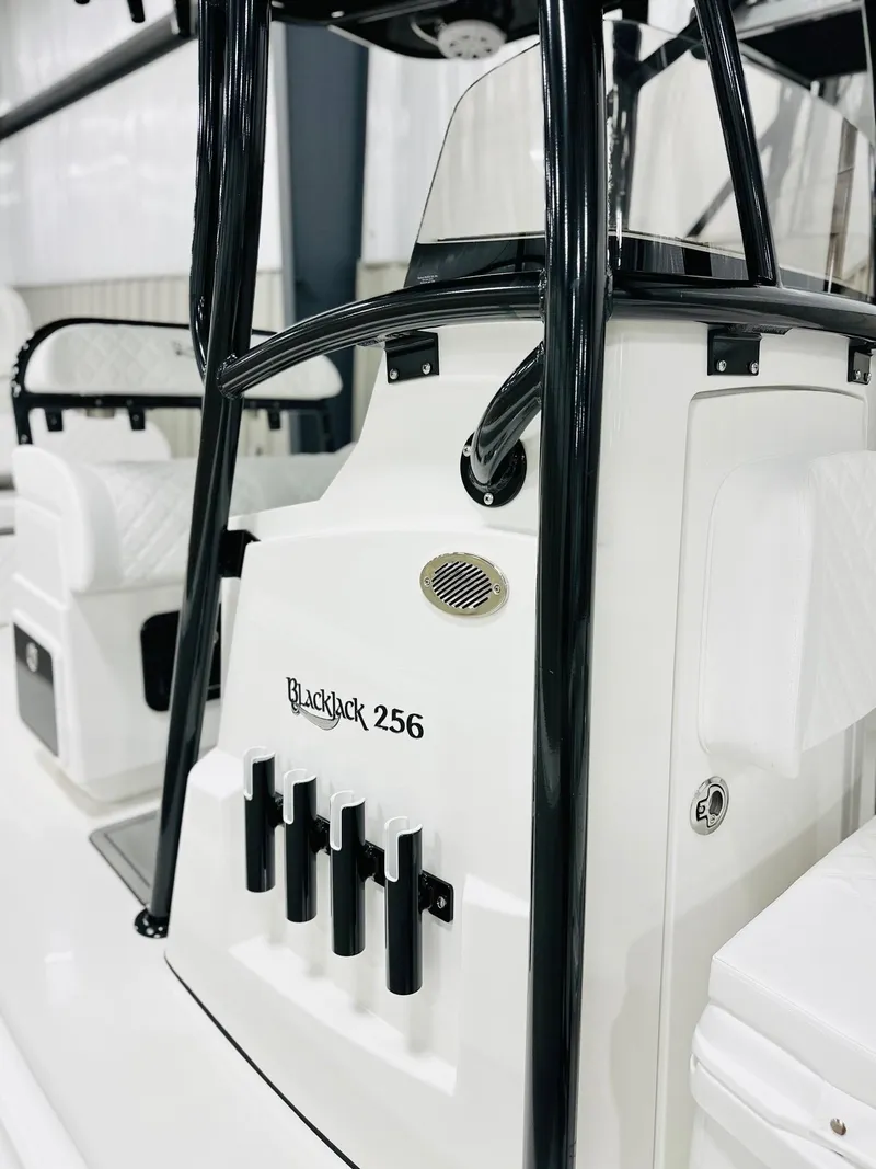 Slide: The Image of 2026 BlackJack 256 Coastal boat interior with rod holders and sleek design. - 9