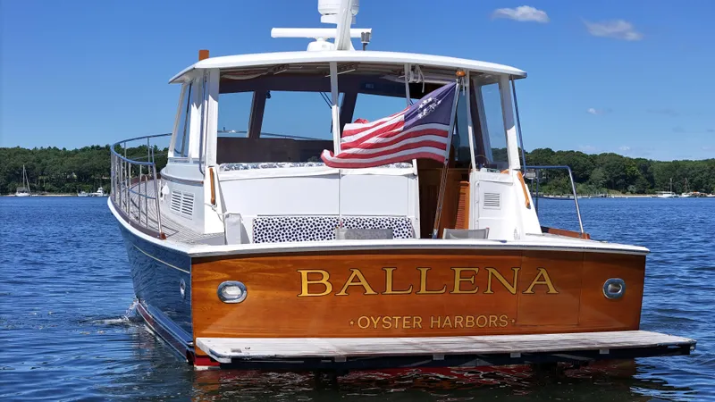 Slide: The Image of 2002 Grand Banks 49 Eastbay HX yacht "Ballena" on water, displaying American flag. - 11