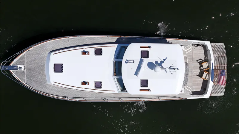 Slide: The Image of Overhead view of 2002 Grand Banks 49 Eastbay HX yacht on water. - 13