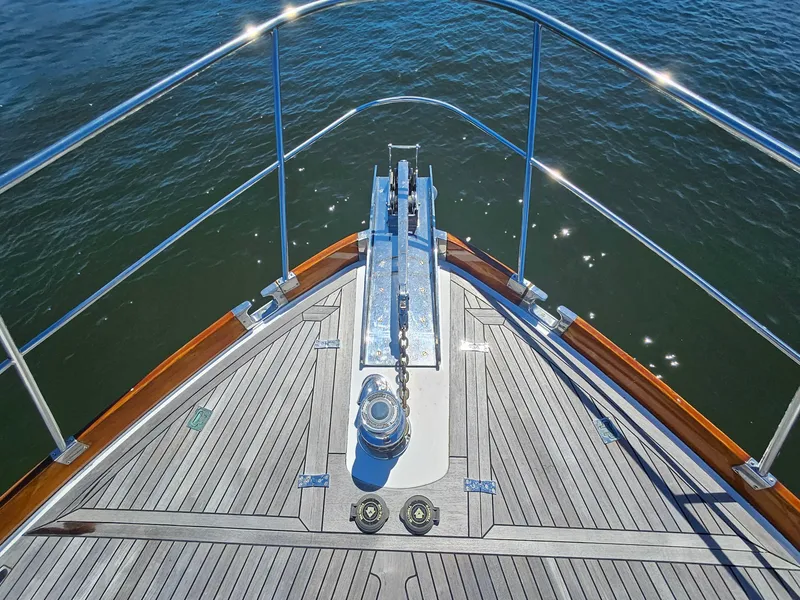 Slide: The Image of Bow of 2002 Grand Banks 49 Eastbay HX yacht with anchor chain and teak deck. - 15