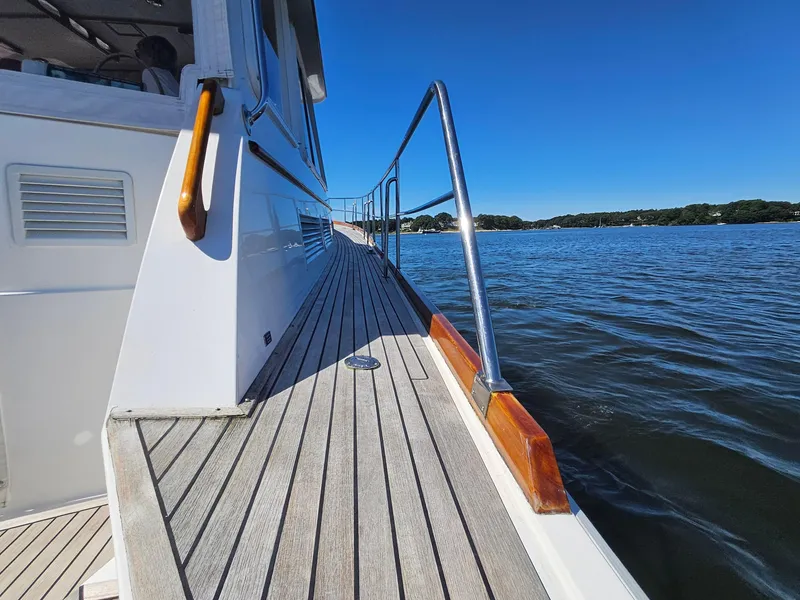 Slide: The Image of 2002 Grand Banks 49 Eastbay HX yacht deck with ocean view and clear blue sky. - 18