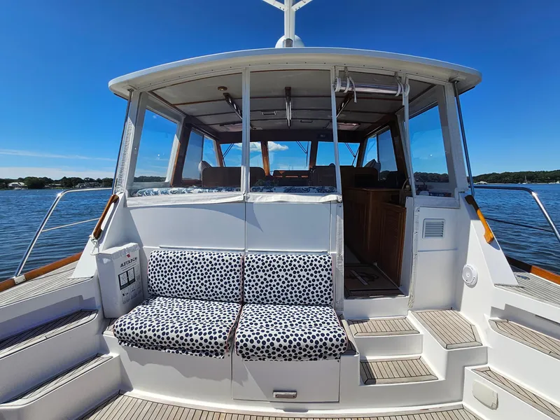 Slide: The Image of 2002 Grand Banks 49 Eastbay HX yacht with polka dot seating, docked on a sunny day. - 21