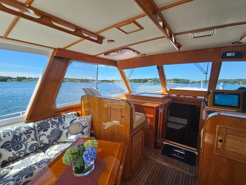 Slide: The Image of Luxurious 2002 Grand Banks 49 Eastbay HX yacht interior with elegant wood finish and scenic water view. - 24