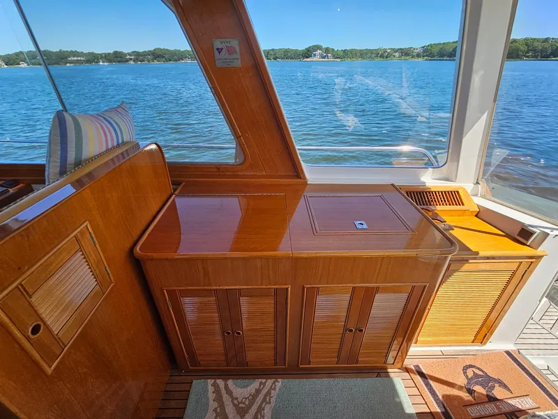 Slide: The Image of Interior of 2002 Grand Banks 49 Eastbay HX yacht with wooden cabinetry and scenic water view. - 25