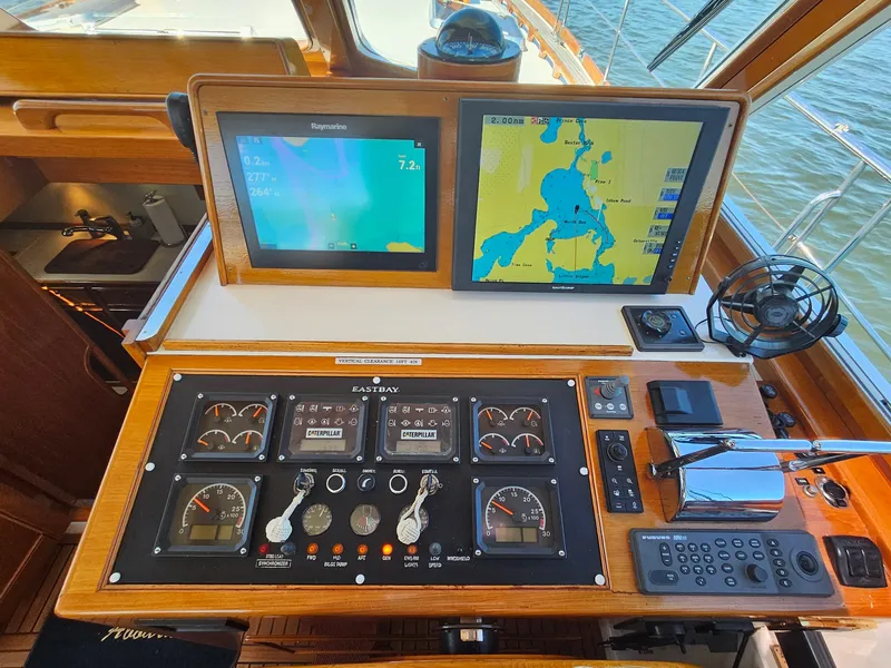 Slide: The Image of Control panel of 2002 Grand Banks 49 Eastbay HX with navigation screens and gauges. - 28