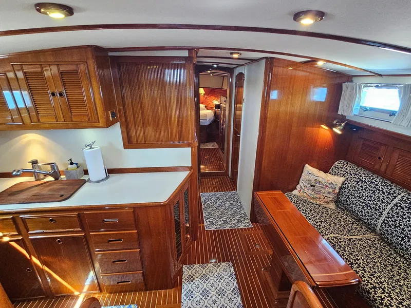 Slide: The Image of Luxurious 2002 Grand Banks 49 Eastbay HX yacht interior with elegant wood finishes and cozy seating. - 35