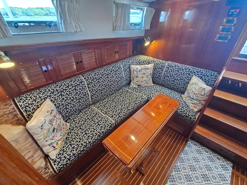 Slide: The Image of Luxurious 2002 Grand Banks 49 Eastbay HX yacht interior with elegant seating and wooden finishes. - 36