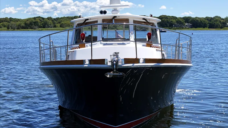 Slide: The Image of 2002 Grand Banks 49 Eastbay HX yacht on calm water, front view. - 4