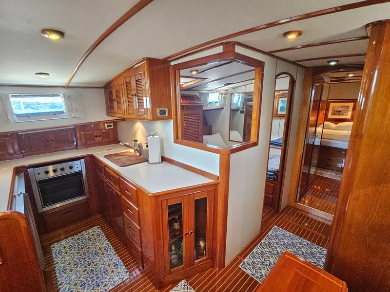 Slide: The Image of Luxurious 2002 Grand Banks 49 Eastbay HX yacht interior with wood cabinetry and modern kitchen. - 40