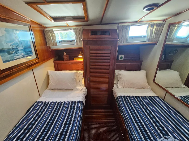 Slide: The Image of Twin cabin interior of 2002 Grand Banks 49 Eastbay HX yacht with striped bedding. - 43