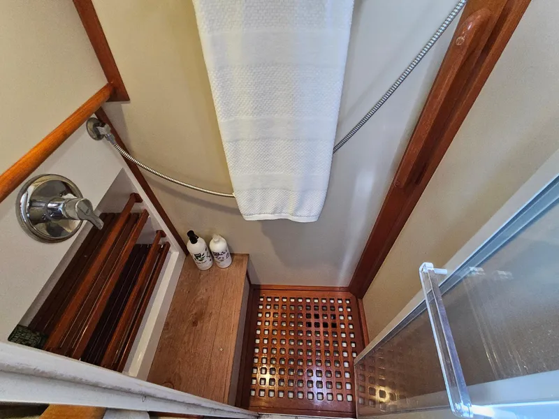 Slide: The Image of Shower area in 2002 Grand Banks 49 Eastbay HX yacht with wooden accents and toiletries. - 45