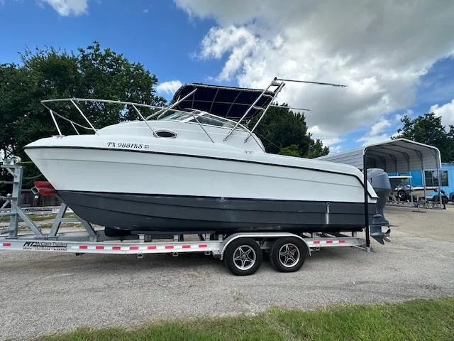 Slide: The Image of 2006 Glacier Bay 2240 SX Renegade boat on trailer under blue sky. - 0