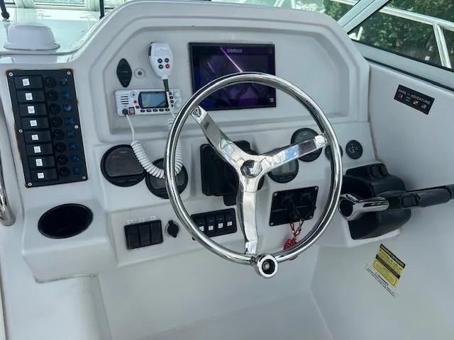 Slide: The Image of Helm of 2006 Glacier Bay 2240 SX Renegade with steering wheel and control panel. - 11