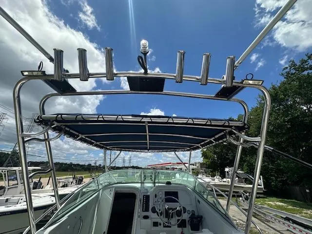 Slide: The Image of 2006 Glacier Bay 2240 SX Renegade boat with canopy and rod holders under a blue sky. - 13