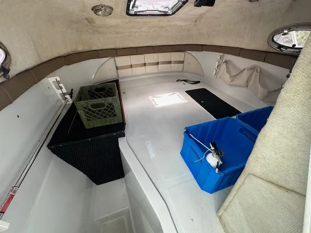 Slide: The Image of Interior cabin of 2006 Glacier Bay 2240 SX Renegade boat with storage crates. - 17