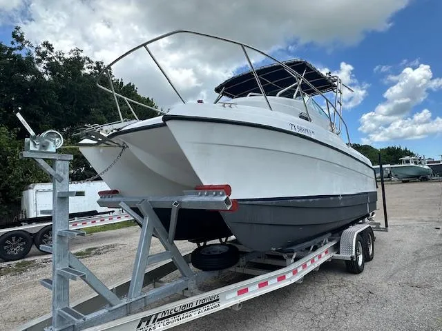 Slide: The Image of 2006 Glacier Bay 2240 SX Renegade boat on trailer under cloudy sky. - 2