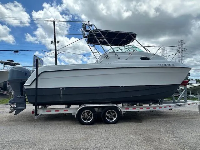 Slide: The Image of 2006 Glacier Bay 2240 SX Renegade boat on trailer under cloudy sky. - 4