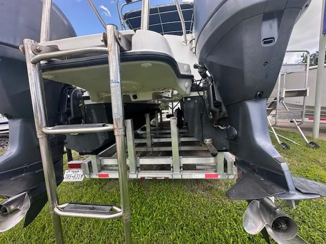 Slide: The Image of 2006 Glacier Bay 2240 SX Renegade boat on trailer, rear view with dual outboard motors. - 7