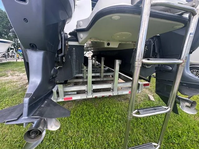 Slide: The Image of 2006 Glacier Bay 2240 SX Renegade boat on trailer, showing dual outboard motors and ladder. - 8