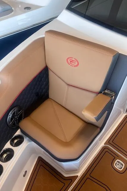 Slide: The Image of 2025 Cobalt R6 Surf boat seat with tan upholstery and cup holders. - 10