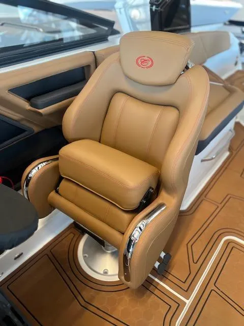 Slide: The Image of Luxurious tan captain's chair in 2025 Cobalt R6 Surf boat interior. - 19