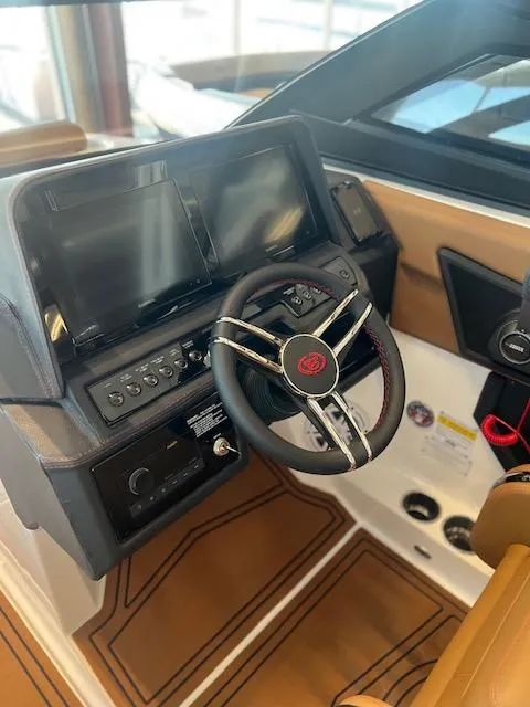 Slide: The Image of 2025 Cobalt R6 Surf boat dashboard with modern controls and sleek steering wheel design. - 20