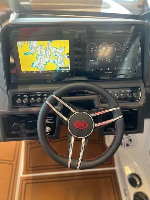 Slide: The Image of 2025 Cobalt R6 Surf dashboard with navigation and control screens, featuring a sleek steering wheel. - 21