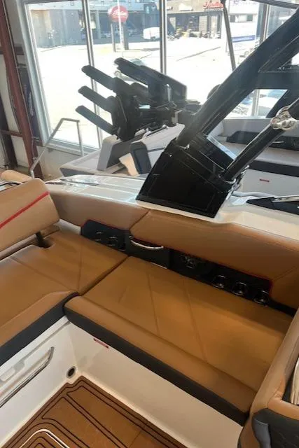 Slide: The Image of 2025 Cobalt R6 Surf boat interior with tan seating and sleek design. - 23