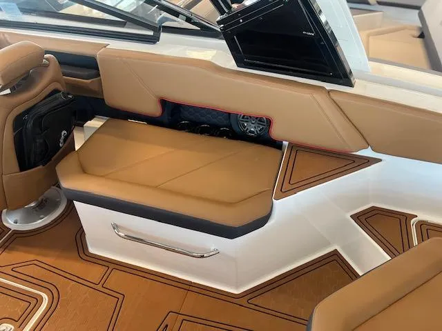 Slide: The Image of 2025 Cobalt R6 Surf boat interior with tan seating and modern design elements. - 25
