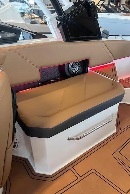 Slide: The Image of 2025 Cobalt R6 Surf boat interior with tan seating and modern design elements. - 27
