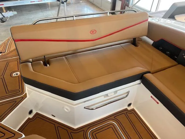 Slide: The Image of 2025 Cobalt R6 Surf boat interior with tan seating and red accents. - 28