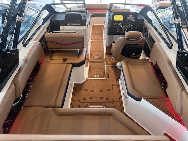 Slide: The Image of 2025 Cobalt R6 Surf boat interior with luxurious tan seating and modern dashboard. - 30