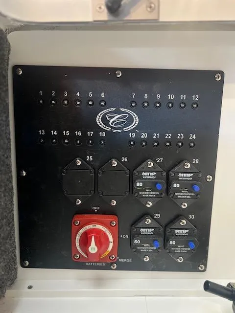 Slide: The Image of Control panel of 2025 Cobalt R6 Surf boat with switches and circuit breakers. - 33
