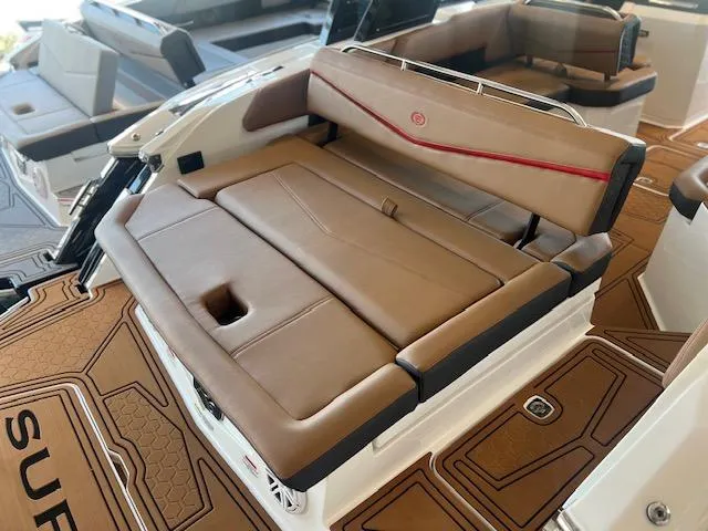 Slide: The Image of 2025 Cobalt R6 Surf boat interior with tan leather seating and modern design. - 35