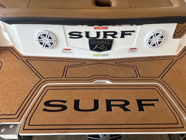 Slide: The Image of 2025 Cobalt R6 Surf boat with teak deck and stereo speakers. - 37