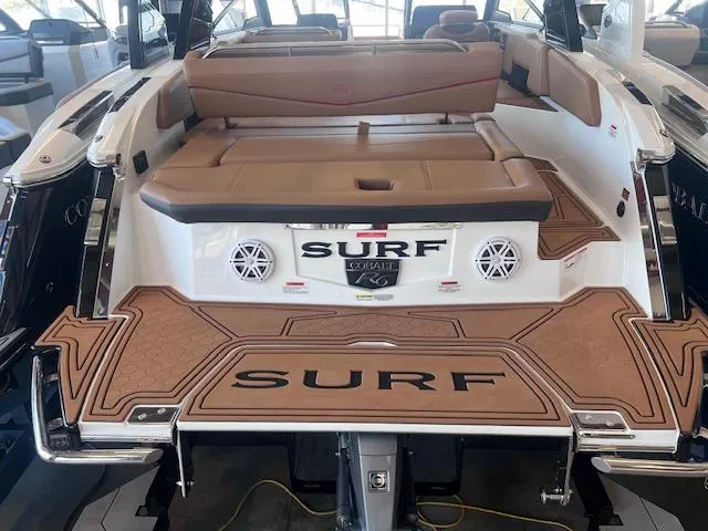 Slide: The Image of 2025 Cobalt R6 Surf boat with tan seating and "Surf" branding on deck. - 38