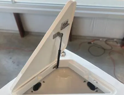 Slide: The Image of 2025 Cobalt R6 Surf boat storage compartment with open lid and hydraulic support. - 4
