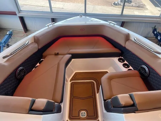 Slide: The Image of 2025 Cobalt R6 Surf boat interior with tan seating and ambient lighting. - 7