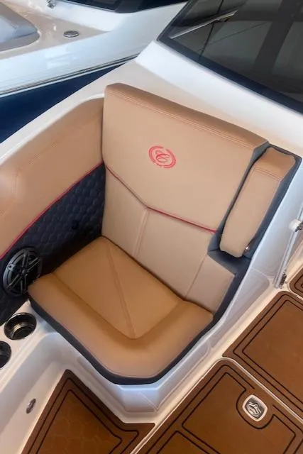Slide: The Image of 2025 Cobalt R6 Surf boat seat with tan upholstery and red accents. - 8