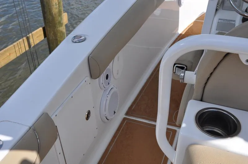Slide: The Image of Interior of 2015 Sea Hunt Gamefish 30 boat, featuring seating and cup holder. - 19