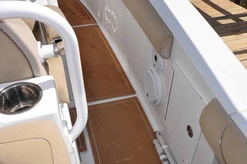 Slide: The Image of 2015 Sea Hunt Gamefish 30 interior with tan seating and white speaker. - 20